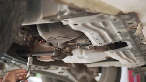 Draining old lubricant from car engine Stock Footage 139026959