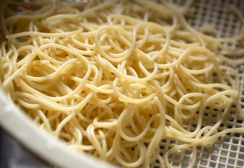 Draining pasta in plastic colander strainer Stock Photos