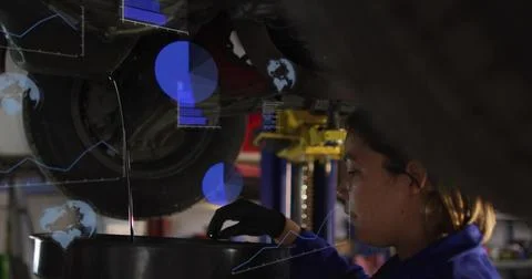 Draining tech holding oil flow into drain pan under vehicle blue overalls black Stock Photos