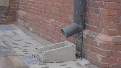 Drainpipe connected to the red brick building Stock Footage 299893041