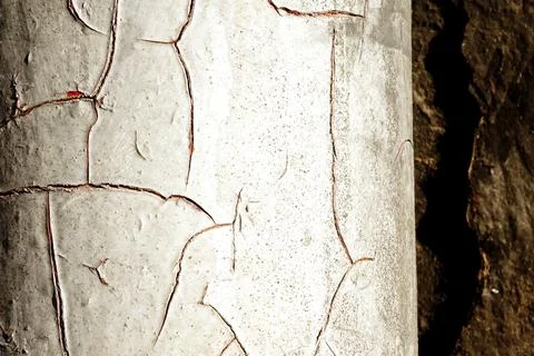 Drainpipe with cracked white paint with reddish cracks Stock Photos