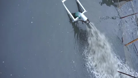 Drains the lake through a pipe vertical video Stock Footage 256995935