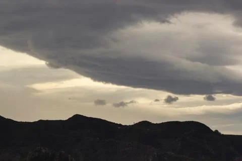 Dramaric sky clouds floating over valley Stock Photos