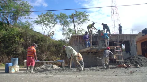 Dramati image of construction workers mixing cement for a roof on a house. Stock Footage 147229769