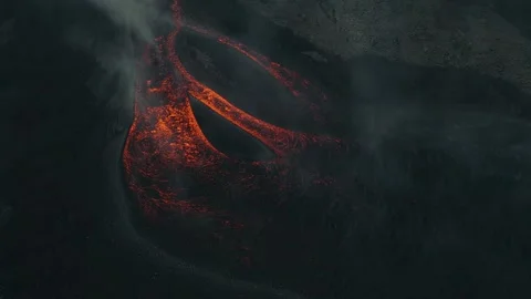 Dramatic 4K Aerial Shot of Molten Lava Flowing Through Smoke Stock Footage 329198947