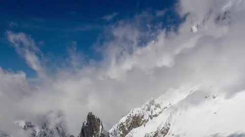 Dramatic 4K Aerial View of Snowy Mountain Peaks Under Dramatic Sky Vídeos de archivo 329199985