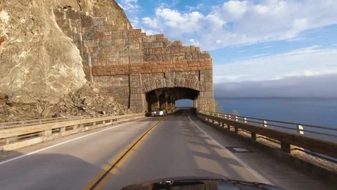 Dramatic 4K Drive Through Scenic Coastal Tunnel on Sunny Day Stock Footage 323835215