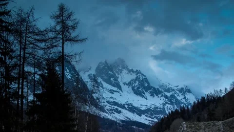 Dramatic 4K Mountain Landscape under Overcast Sky at Dusk Stock Footage 329199906