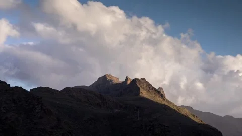 Dramatic 4K Mountain Peaks Under Dynamic Cloudscape at Sunset Stock-Footage 329198956