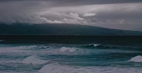 Dramatic 4K Ocean Waves Crashing on Rugged Shore Under Stormy Sky Stock Footage 323836073