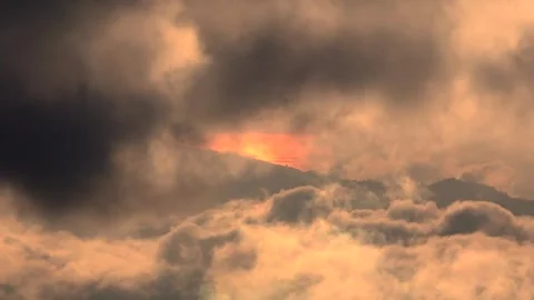 Dramatic 4K Sunset Breaking Through Clouds Over Mountain Range Stock Footage 328629285