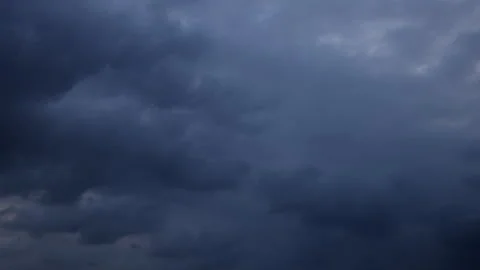 A dramatic 4K time-lapse of dark storm clouds rolling across the sky. Stock Footage 341579808