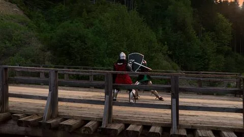 Dramatic action scene Two knights in medieval armor duel in battle unfolds on Stock Photos