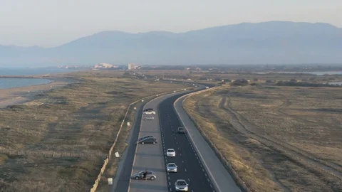Dramatic aerial circling camera over sunset road  Stock Footage 112714518