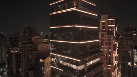 Dramatic Aerial Dolly-Out of an Illuminated Corporate Skyscraper at Night Stock Footage 321706233