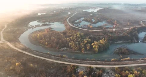 Dramatic aerial drone footage of a small river by the lake. Cinematic rotating Video stock 198357006