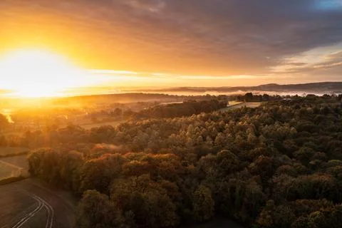 Dramatic aerial drone landscape image of Autumn Fall forest in misty mornin.. Stock Photos