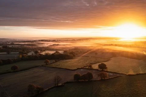 Dramatic aerial drone landscape image of Autumn Fall forest in misty mornin.. Stock Photos