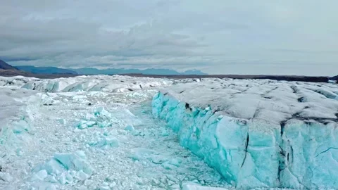 Dramatic aerial flight over vast glacier and ice floes in Iceland showing global Stock Footage 343696424