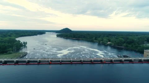 Dramatic aerial flyover shot of a dam in full release mode. Camera tilts down. Stock Footage 136070705