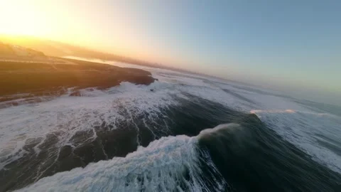 Dramatic aerial footage of ocean waves at sunset Video stock 346074833