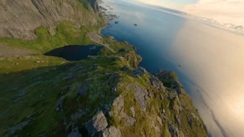 Dramatic Aerial FPV Drone Flight Over Norwegian Mountain Ridge to Open Ocean Video stock 346835851