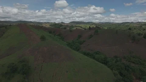 Dramatic Aerial of Green Hills With Bold Earthy Stripes, Clouds Breaking Th.. Stock-Footage 337600494