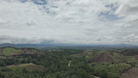 Dramatic Aerial of Open Grassland Pasture, Dense Tropical Forest and Distin.. Stock Footage 337531372