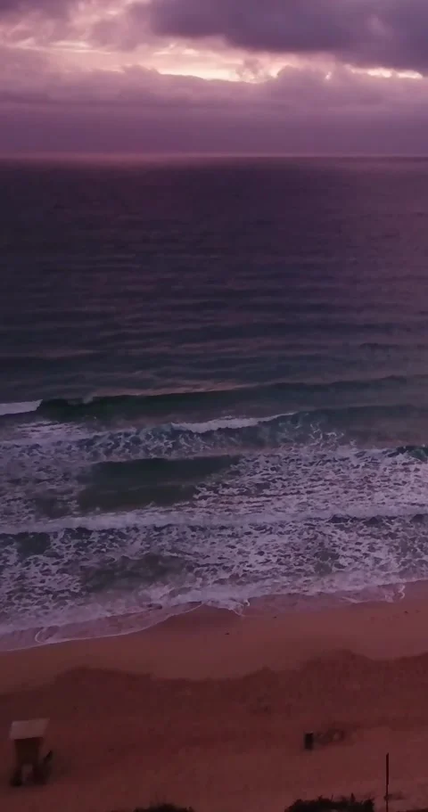 Dramatic aerial perspective capturing ocean waves with white foam gently Stock Footage 344841787