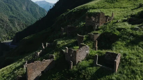 Dramatic Aerial Perspective of Dense Forest Valley with Winding Road and River Stock Footage 265593943
