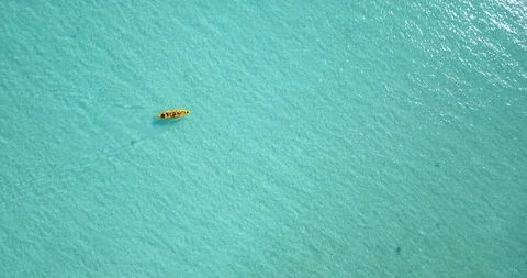 Dramatic aerial perspective high above a young couple as they paddle Stock Footage 102619145