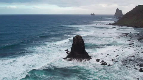 Dramatic aerial perspective of the rugged coastline at Benijo beach, featuring Stock Footage 331464223