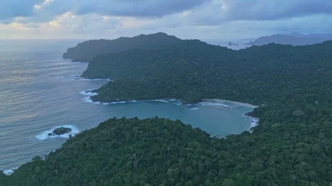 Dramatic aerial perspective of the rugged coastline of red island in java Stock Footage 331632054