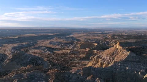Dramatic Aerial Perspective of Striated Desert Peaks and Expansive Skyward Stock Footage 325771404