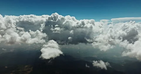Dramatic aerial shot of clouds wrapping around jagged Stock Footage 303302477
