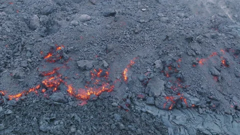Dramatic aerial shot on drone of red hot lava flowing and freezing with smoke 4K 스톡 동영상 238652237