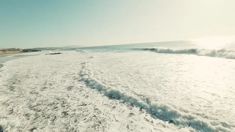 Dramatic aerial shot of powerful waves hitting rocky shore Stock Footage 339790890