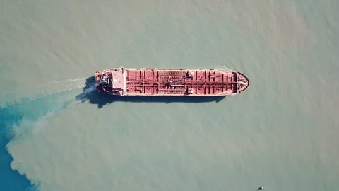Dramatic Aerial shot of red deck tanker ship sailing on open sea with pollution Stock Footage 110731610