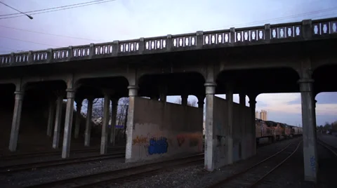 Dramatic aerial shot of train under bridge Video stock 33737998