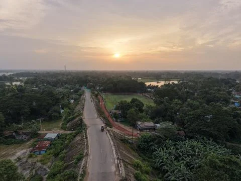 Dramatic aerial sunset view over green countryside fields and river landscape Stock Photos