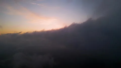 Dramatic aerial sunset view through heavy clouds. Golden light breaking through Stock-Footage 330901613
