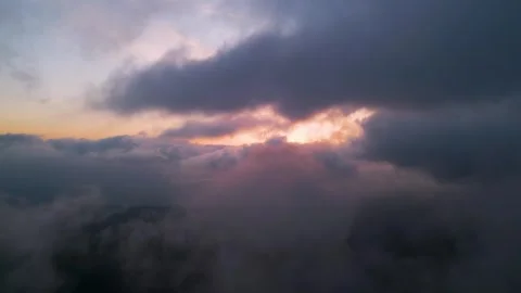 Dramatic aerial sunset view through heavy clouds. Golden light breaking through 库存影片 330901616