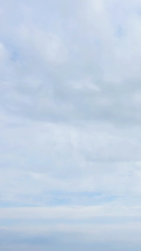 A dramatic aerial timelapse of fluffy clouds drifting across a blue sky Stock Footage 304194353