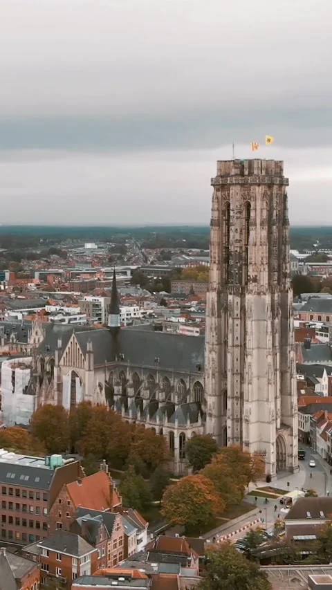 Dramatic aerial vertical shot of Saint Rumbold’s Cathedral in Mechelen, Belgium Stock Footage 310761037
