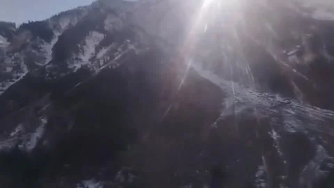 A dramatic aerial video of a mountain range with vibrant sunlight Stock Footage 325688227