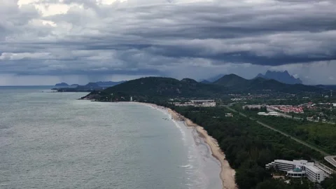 Dramatic aerial view of coastline as tropical storm clouds build up during rainy Stock Footage 314303078
