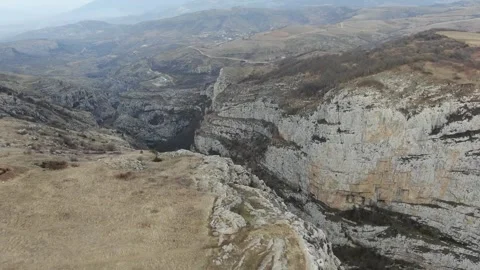 Dramatic Aerial View of a Deep Canyon Landscape with Steep Cliffs Stock Footage 341892722