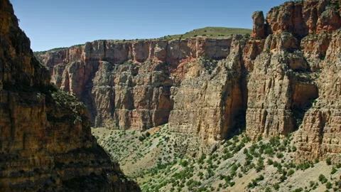 Dramatic aerial view deep inside a steep Canyon near Big Horn Canyon, Montana Stock Footage 260752916