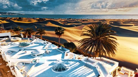 Dramatic aerial view of Gran Canaria's coastal dunes at sunset Stock Footage 296920620