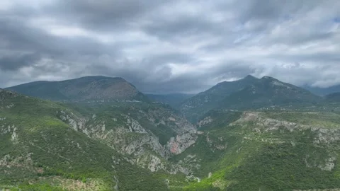 Dramatic Aerial View of Green Mountains and Storm Clouds in Mani Stock Footage 335657854
